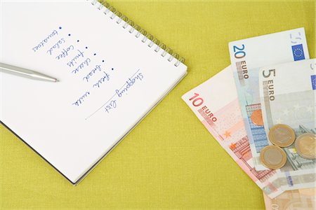 Close-up of Money and Shopping List, Dusseldorf, North Rhine-Westphalia, Germany Stock Photo - Premium Royalty-Free, Code: 600-02660173