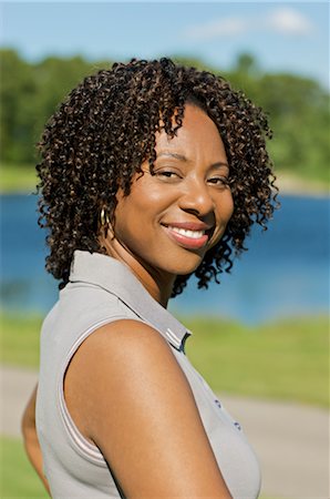 single middle aged african american woman looking at camera - Portrait of Woman, Burlington, Ontario, Canada Stock Photo - Premium Royalty-Free, Code: 600-02670427