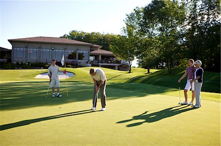 father and son play with a ball - Couples Golfing, Burlington, Ontario, Canada Stock Photo - Premium Royalty-Free, Code: 600-02670444