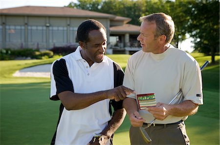 Golfers Looking at Score Card, Burlington, Ontario, Canada Stock Photo - Premium Royalty-Free, Code: 600-02670458