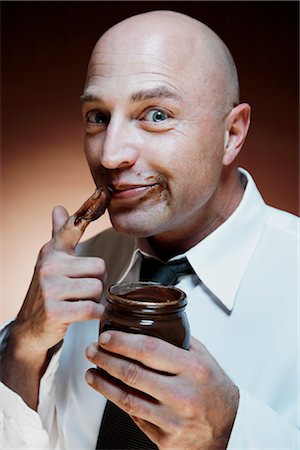 excess of junk food - Man Eating Chocolate Spread Stock Photo - Premium Royalty-Free, Code: 600-02670688