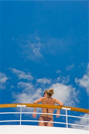 Rear View of Woman in Bikini Leaning Against Railing on Cruise Ship Stock Photo - Premium Royalty-Free, Code: 600-02671114