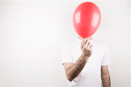 Man Holding Balloon Stock Photo - Premium Royalty-Free, Code: 600-02685977