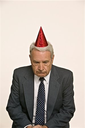 sad 60 year old people - Homme d'affaires portant chapeau de fête Photographie de stock - Premium Libres de Droits, Code: 600-02694644