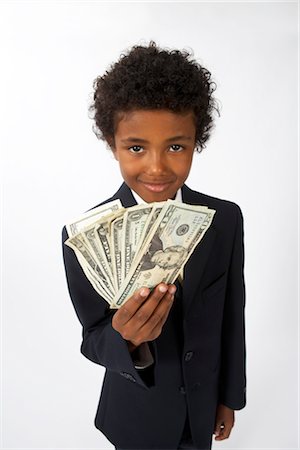 Little Boy Dressed Up as a Businessman Holding Cash Stock Photo - Premium Royalty-Free, Code: 600-02693727