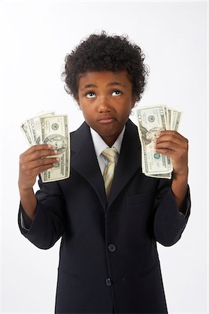 rolling eyes - Little Boy Dressed Up as a Businessman Holding Cash Stock Photo - Premium Royalty-Free, Code: 600-02693728