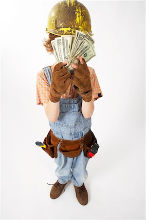 Little Boy Dressed Up as Construction Worker Holding Cash Stock Photo - Premium Royalty-Free, Code: 600-02693754