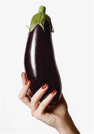 single aubergine - Woman's Hand Holding Eggplant Stock Photo - Premium Royalty-Free, Code: 600-02693868