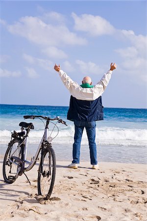 senior only - Man Standing on the Beach With Arms in Air Stock Photo - Premium Royalty-Free, Code: 600-02693897