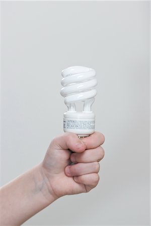 simsearch:632-07674478,k - Child Holding Energy Efficient Lightbulb Stock Photo - Premium Royalty-Free, Code: 600-02700897