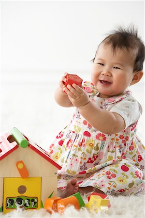 ethnic baby white background - Girl Playing with Shapes and House Stock Photo - Premium Royalty-Free, Code: 600-02701244