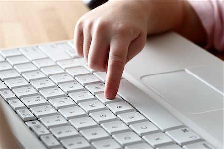 Girl's Hand on Keyboard Fotografie stock - Premium Royalty-Free, Codice: 600-02701257