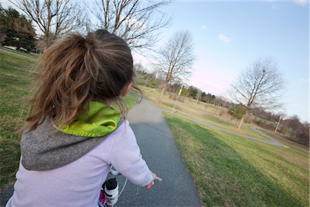 ponytail back view girl - Young Girl Riding Bicycle Stock Photo - Premium Royalty-Free, Code: 600-02724720