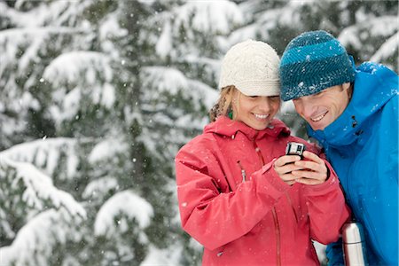 Close-up of Couple Using PDA Outdoors in Winter, Whistler, British Columbia, Canada Stock Photo - Premium Royalty-Free, Code: 600-02757266