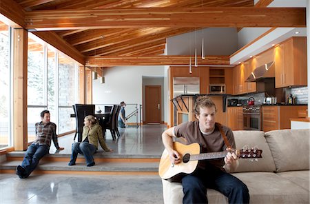 expensive modern house - Friends Hanging Out at Home, Man Playing the Guitar Stock Photo - Premium Royalty-Free, Code: 600-02757347