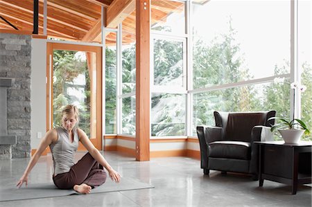 Woman Doing Yoga in Living Room of Large Alpine Home Stock Photo - Premium Royalty-Free, Code: 600-02757358