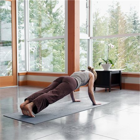 simsearch:600-02757348,k - Woman Doing Yoga in Living Room of Large Alpine Home Stock Photo - Premium Royalty-Free, Code: 600-02757361