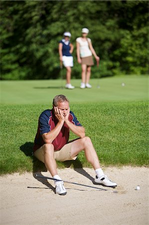 simsearch:700-00528371,k - Man Sitting by Sand Trap on Golf Course Stock Photo - Premium Royalty-Free, Code: 600-02751484