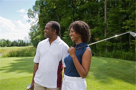 fun with black friends - Couple holding Golf Clubs Stock Photo - Premium Royalty-Free, Code: 600-02751504