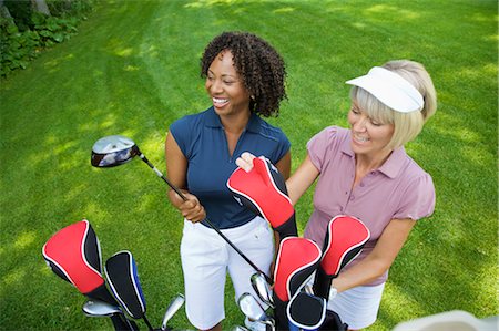 simsearch:600-02701112,k - Women Choosing Golf Clubs Fotografie stock - Premium Royalty-Free, Codice: 600-02751514