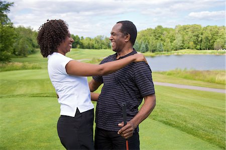 senior golfing - Couple Embracing on Golf Course Stock Photo - Premium Royalty-Free, Code: 600-02751518