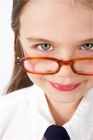 school elementary uniform - Girl Looking over Glasses Stock Photo - Premium Royalty-Free, Code: 600-02786876