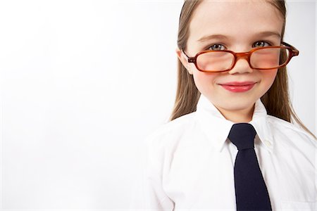 female executive portrait on white - Girl Looking over Glasses Stock Photo - Premium Royalty-Free, Code: 600-02797978