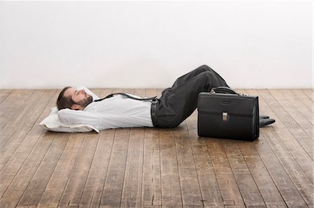 sleep concept - Businessman Lying on Floor Stock Photo - Premium Royalty-Free, Code: 600-02798120