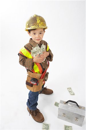 Boy Dressed Up as Construction Worker Holding Money Foto de stock - Sin royalties Premium, Código: 600-02828537