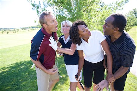 picture of black man playing golf - Women Trying to Break Up Fight Between Golfers Stock Photo - Premium Royalty-Free, Code: 600-02833096