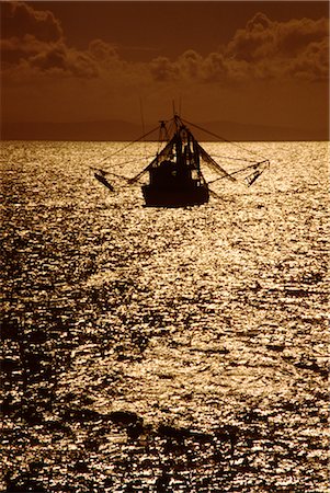 Fishing Boat at Sea, Sunset Silhouette Stock Photo - Premium Royalty-Free, Code: 600-02886058