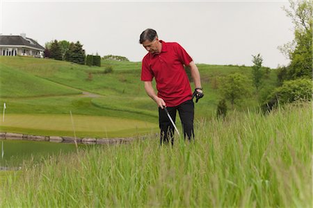 Man Looking for Lost Golf Ball on Golf Course Foto de stock - Sin royalties Premium, Código: 600-02883102