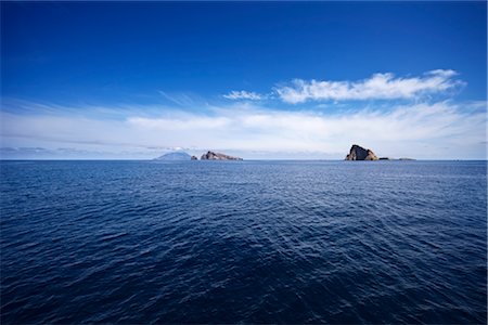 Basiluzzo with Stromboli in Background, Aeolian Islands, Sicily, Italy Stock Photo - Premium Royalty-Free, Code: 600-02912294