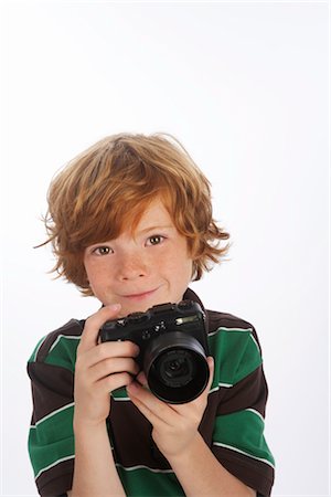 red haired preteen boys - Boy Holding Camera Stock Photo - Premium Royalty-Free, Code: 600-02912765