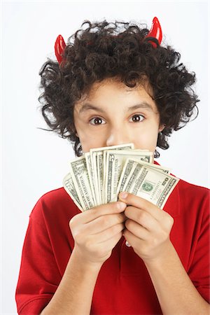 simsearch:600-00933850,k - Little Boy Dressed as Devil Holding Cash Stock Photo - Premium Royalty-Free, Code: 600-02912786