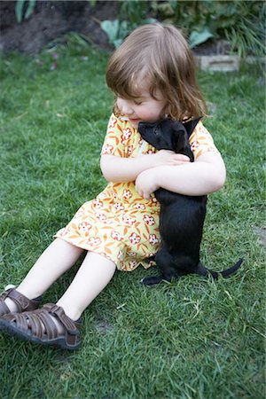 puppy and child - Little Girl Playing With a Puppy Stock Photo - Premium Royalty-Free, Code: 600-02922651