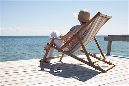 danish (places and things) - Woman Sitting on Deck Chair Stock Photo - Premium Royalty-Free, Code: 600-03017284