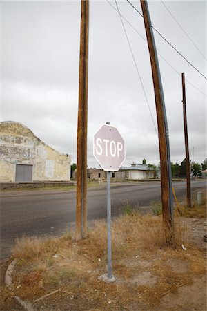 stop sign and road - Faded Stop Sign at Corner, Marfa, Presidio County, West Texas, Texas, USA Stock Photo - Premium Royalty-Free, Code: 600-03017337