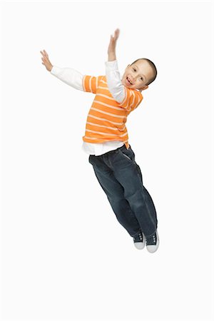 silly boy - Boy Jumping in Studio Stock Photo - Premium Royalty-Free, Code: 600-03017564