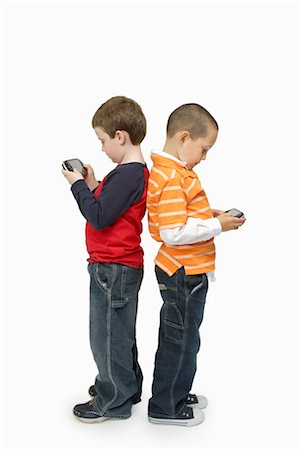 friends white background - Boys with Handheld Video Games Standing Back to Back Stock Photo - Premium Royalty-Free, Code: 600-03017562