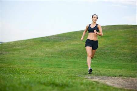 female jogger in sports bra - Woman Running in Park, Seattle, Washington, USA Stock Photo - Premium Royalty-Free, Code: 600-03017920