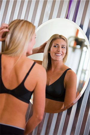 Woman Looking in Mirror Stock Photo - Premium Royalty-Free, Code: 600-03017935