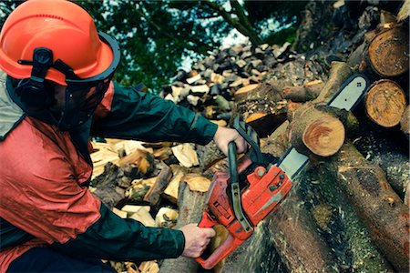 protective clothing - Man Cutting Tree with Chainsaw, Devon, England Stock Photo - Premium Royalty-Free, Code: 600-03059106
