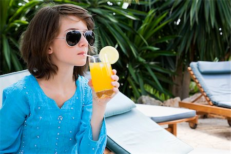 Young Girl Relaxing by the Pool With a Drink Stock Photo - Premium Royalty-Free, Code: 600-03053947