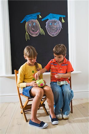 playroom - Boy and Girl putting Money in Piggy Bank for College Fund Stock Photo - Premium Royalty-Free, Code: 600-03084011