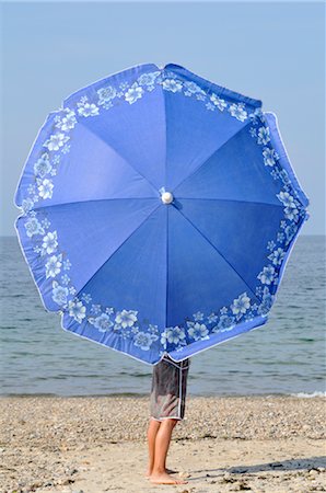 floral design shapes - Boy with Umbrella at Beach Stock Photo - Premium Royalty-Free, Code: 600-03152235