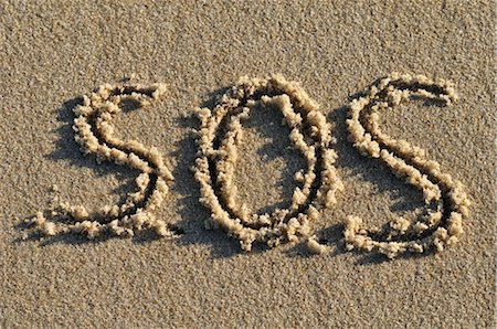 SOS Written in Sand Stock Photo - Premium Royalty-Free, Code: 600-03152291