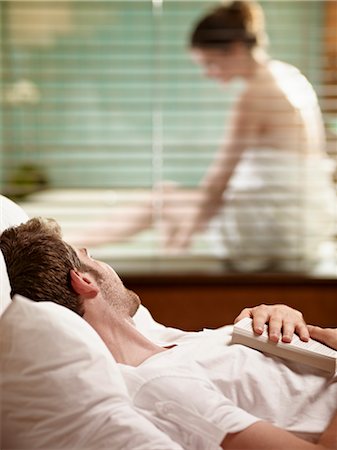 Man Lying in Bed Watching Woman Getting Ready to Take a Bath Stock Photo - Premium Royalty-Free, Code: 600-03178979