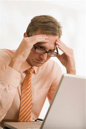 Frustrated Businessman Looking at Laptop Computer Stock Photo - Premium Royalty-Free, Code: 600-03210452