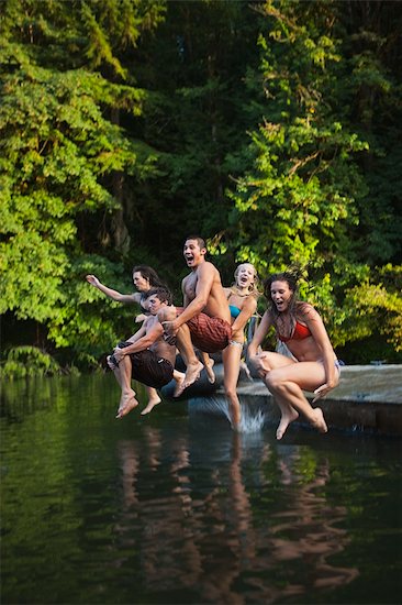 Group of Friends Jumping Into Lake, Near Portland, Oregon, USA Stock Photo - Premium Royalty-Free, Artist: Ty Milford, Image code: 600-03210560